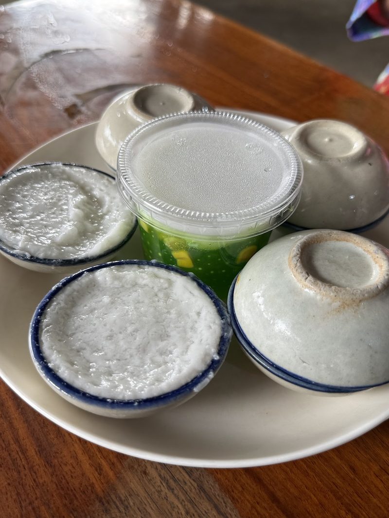 ขนมถ้วยในถ้วยกระเบื้องใบเล็กหลายถ้วยบนจาน